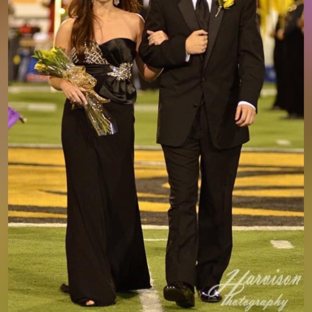 Black evening gown with gold and diamond accents and bow